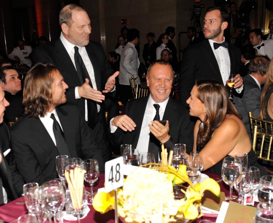  Harvey Weinstein standing, left) and Donna Karan at the amfAR New York Gala in New York in 2011