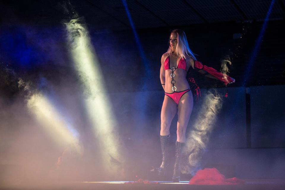  A woman in a bikini stands on stage during a performance