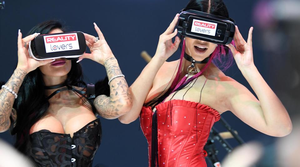  Two women use virtual reality pornography headsets