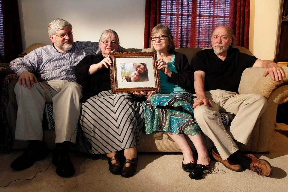 Patrick Boyle, Linda Boyle, Lyn Coleman and Jim Coleman hold photo of their kidnapped children