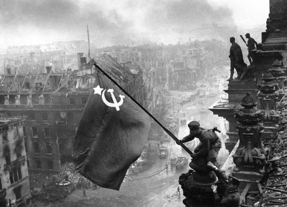  Before: Soviet soldiers raising the hammer and sickle flag over the Reichstag in Berlin, Germany, 1945. The man's wristwatch, bottom, was edited out as it suggested looting had occurred before the photograph was taken