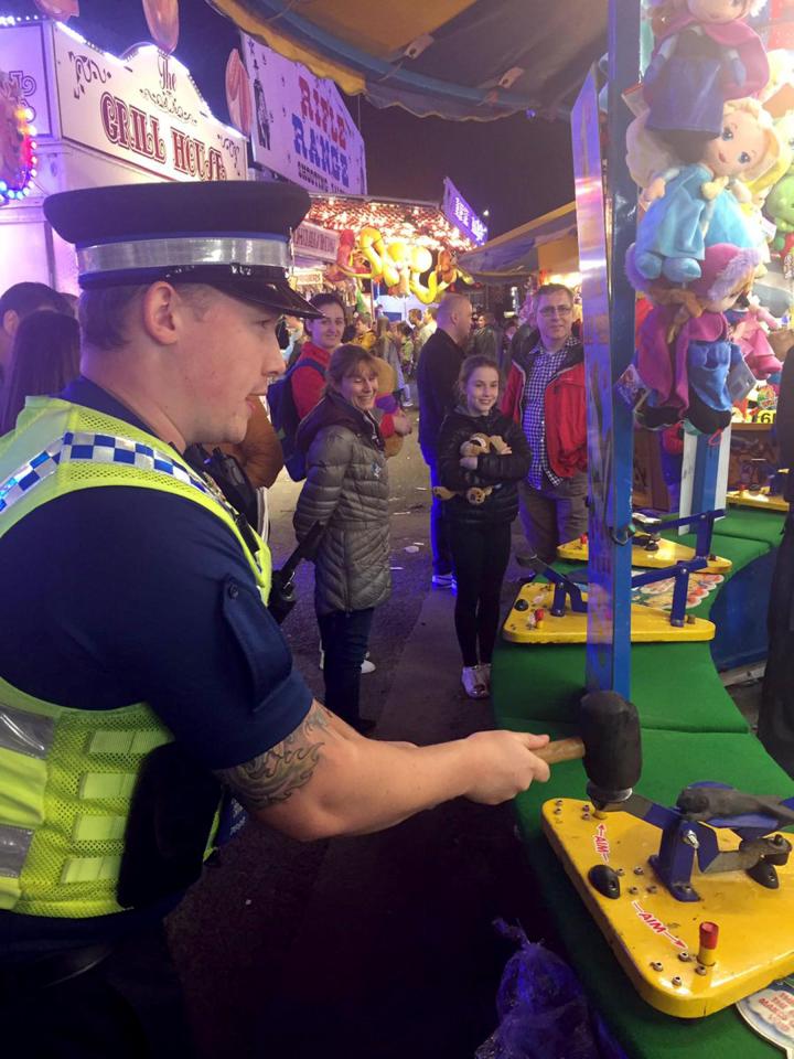  A Humberside policeman has a go on a fairground stall