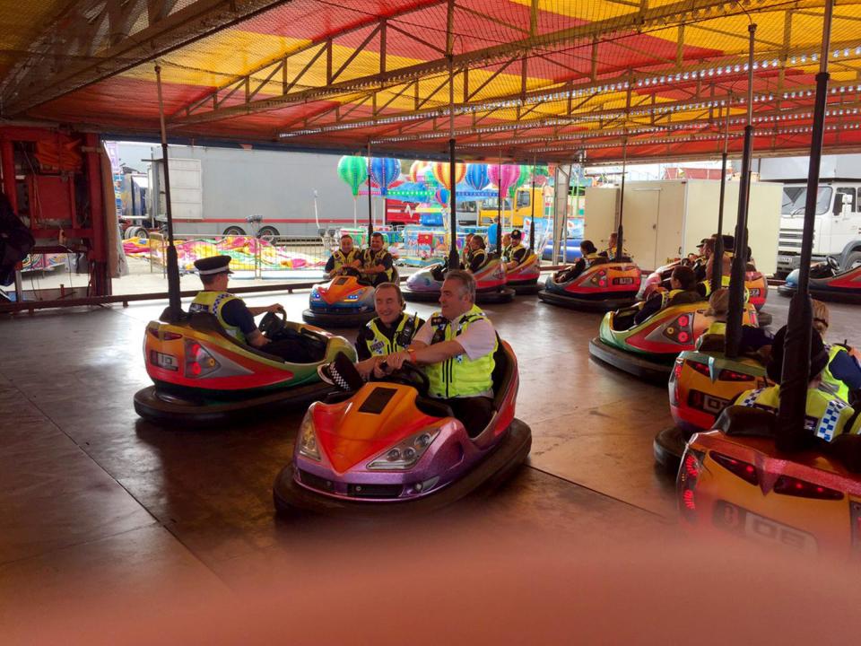  The grin blue line: cops take a ride on the dodgems despite being on duty