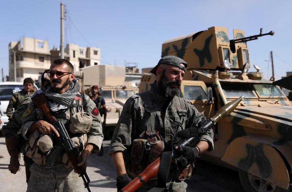  Fighters of Syrian Democratic Forces carry weapons at the frontline in Raqqa, Syria