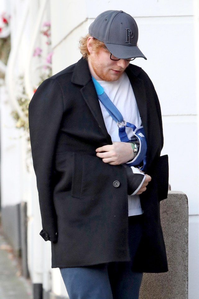 The singer covered up his arms in a large black coat as he returned home from hospital