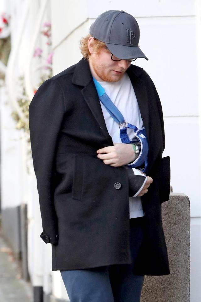  The singer covered up his arms in a large black coat as he returned home from hospital