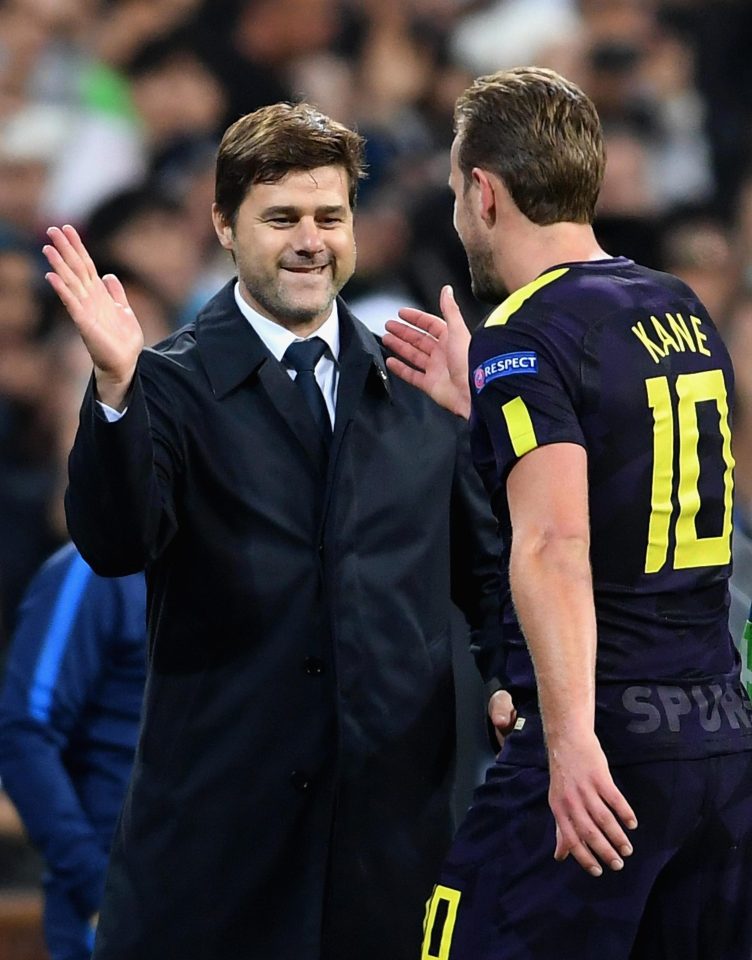  Poch celebrates with his star striker after he clocks up the same number of goals as Champions League peer Cristiano Ronaldo