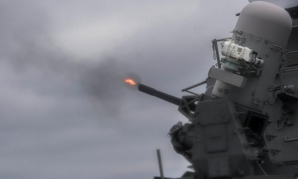  The USS Mustin (DDG 89) fires its close-in weapons system during a live-fire event to the east of the Korean Penninsula in October