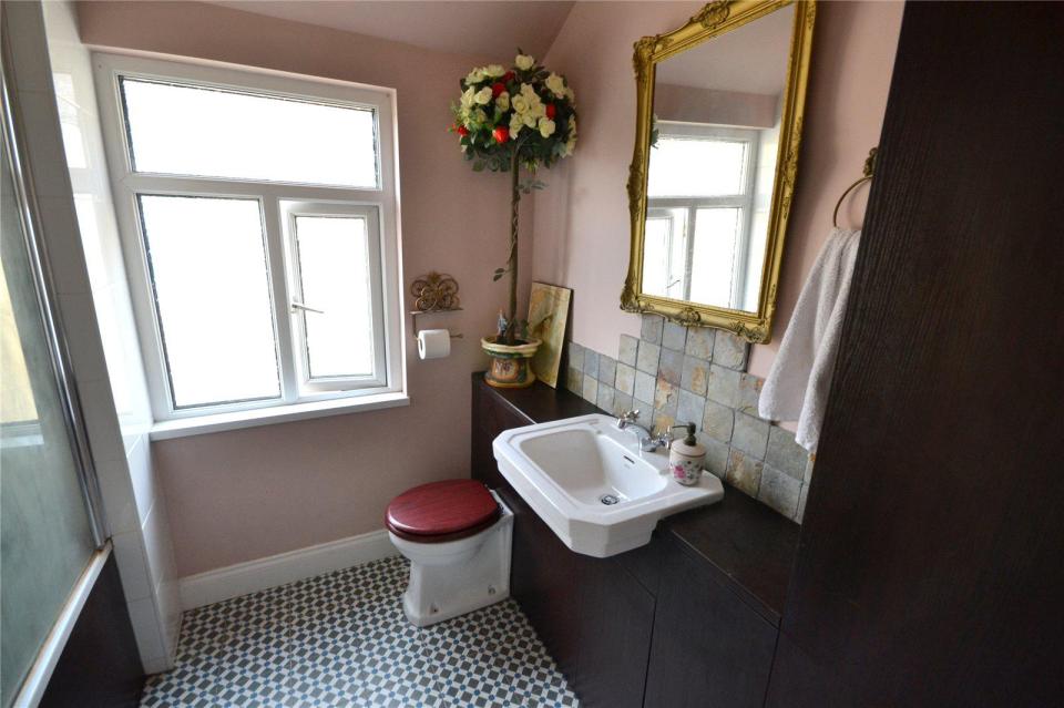 The bathroom has an old-fashioned feel with a traditional wash hand basin and toilet