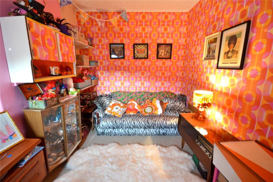 The sitting room has a psychedelic 70s feel to it with the patterned wallpaper and zebra-print sofa