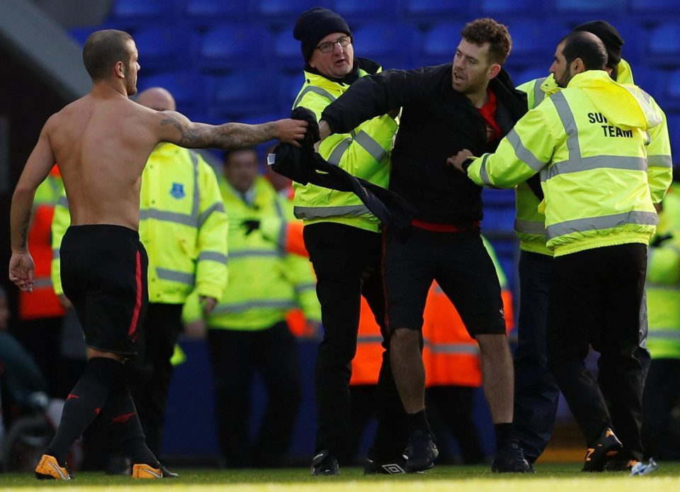  Jack Wilshere hands fan Daniel Dawson his shirt