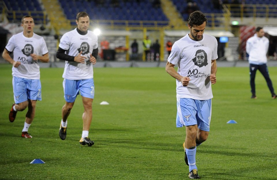  Lazio players wear T-shirts which read 'No to antisemitism' before match