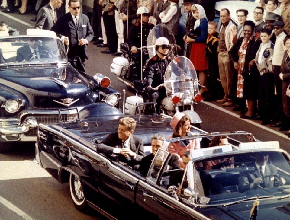 President Kennedy in the limousine in Dallas, Texas, on Main Street, seconds before the assassination