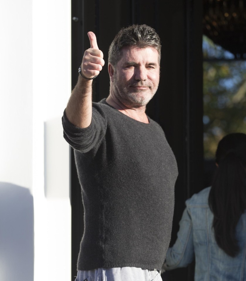 Simon Cowell, 58, gave the thumbs up as he was pictured returning home this afternoon after his horror fall