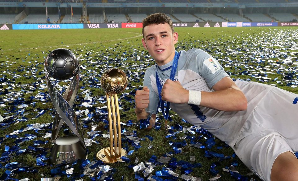  The 17-year-old poses with the World Cup as well as the Golden Ball trophy that he was awarded for his performances in India