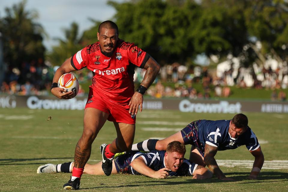  Sika Manu breaks through Scotland's defence in their rugby league World Cup opener