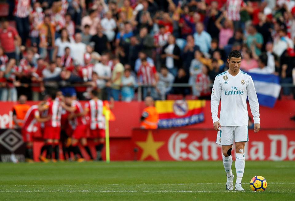  Cristiano Ronaldo looks dejected as Girona players celebrate the winning goal