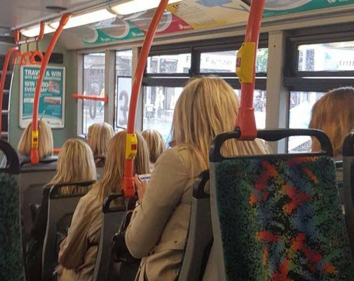  These passengers look identical from behind, as if they had been cloned and pasted into the bus