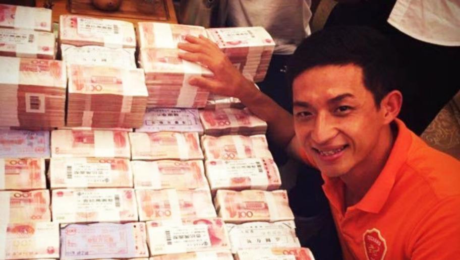  One of the players from the promoted side takes a selfie with a mountain of cash