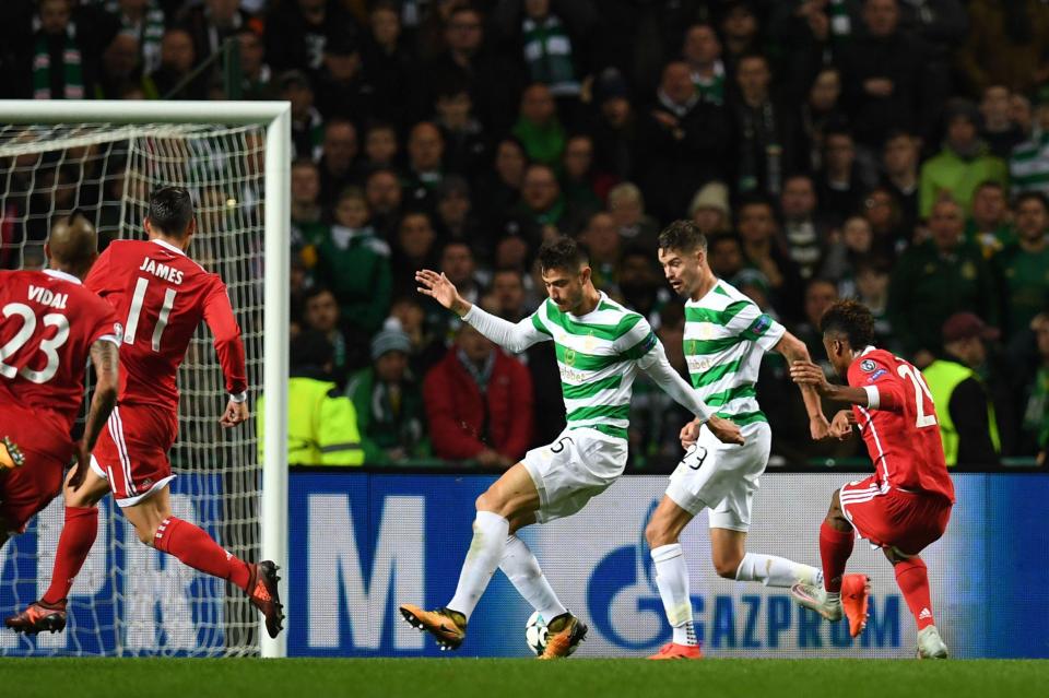  Coman fires in through a crowd of Celtic defenders