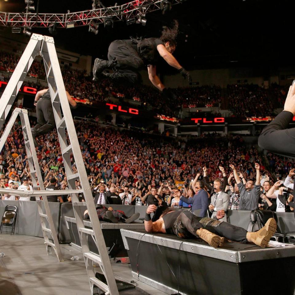  Rollins and Ambrose dive onto their opponents