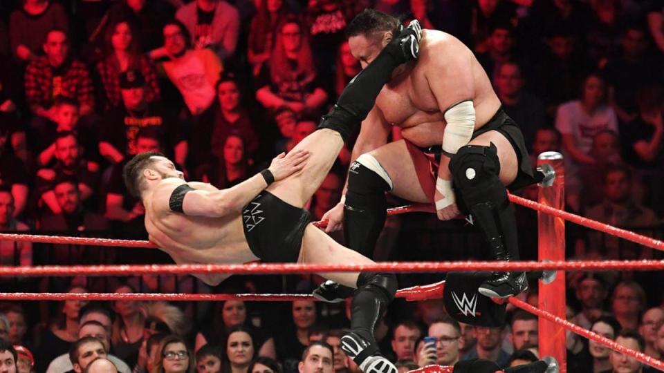  Finn Balor lands a huge kick to Samoa Joe