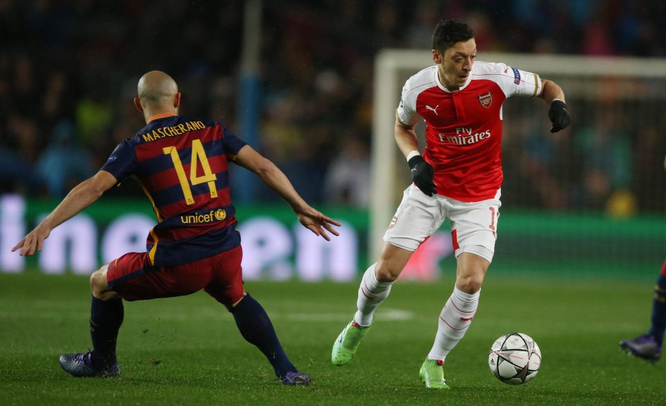  Mesut Ozil in action against Barcelona during Champions League clash