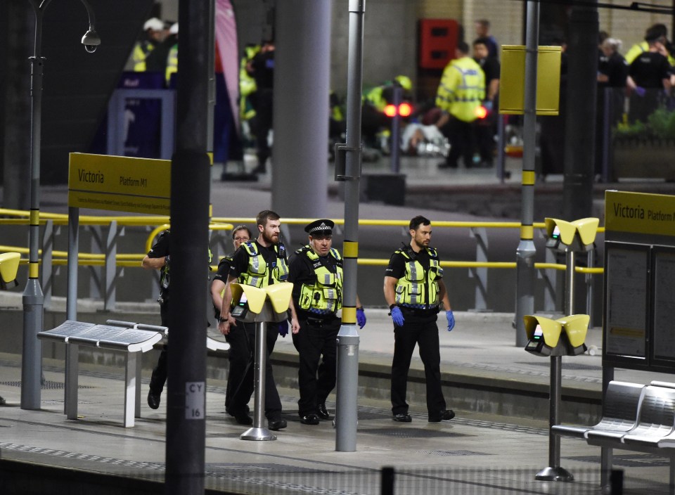 Injured victims being treated on the platform of Manchester’s Victoria Station while police search the station