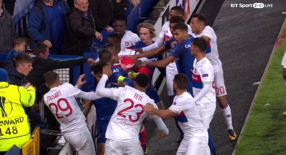  An Everton fan holding a child appears to launch a punch at Anthony Lopes