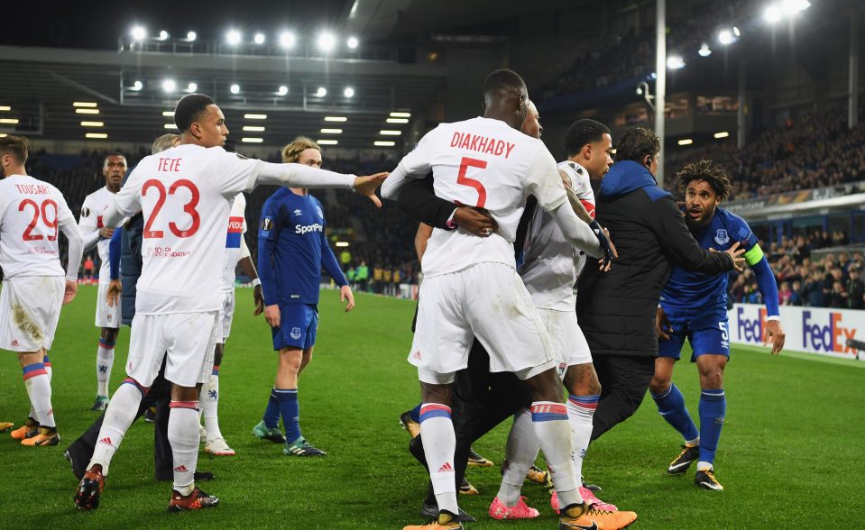  Ashley Williams is being held back during clashes between Everton and Lyon