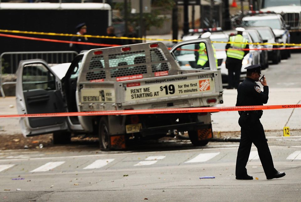  Cops patrol the cordon around the smashed truck in New York this morning