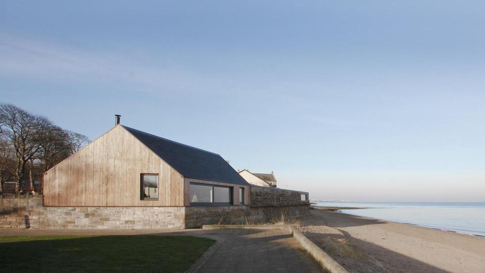  The shore-front home is accessed via a garden courtyard