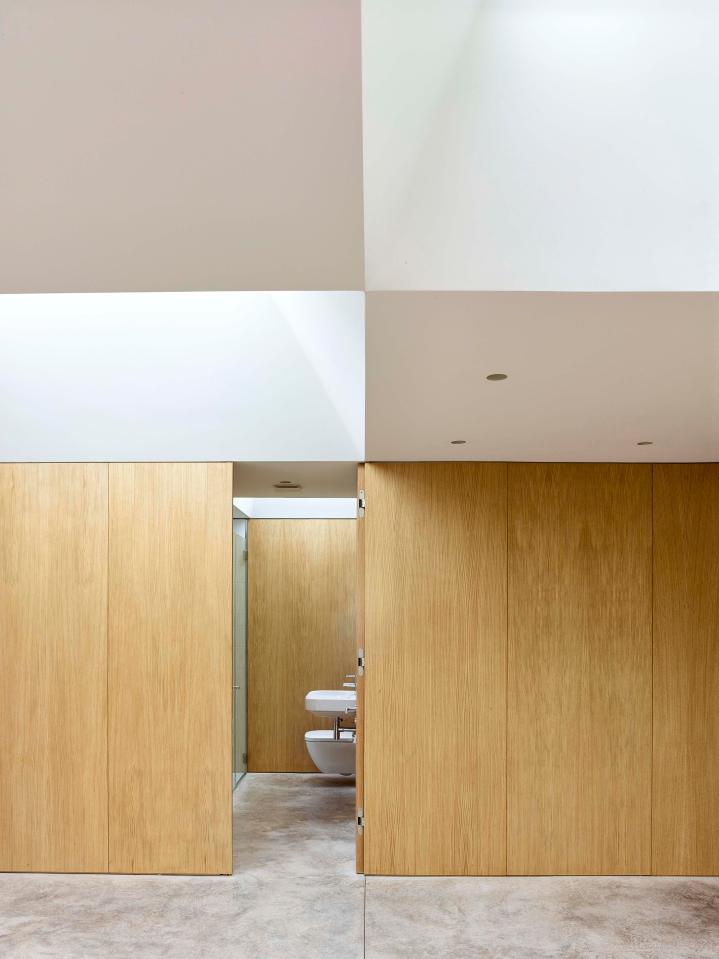  The wooden walls and doors allow for a beautifully minimalist decor