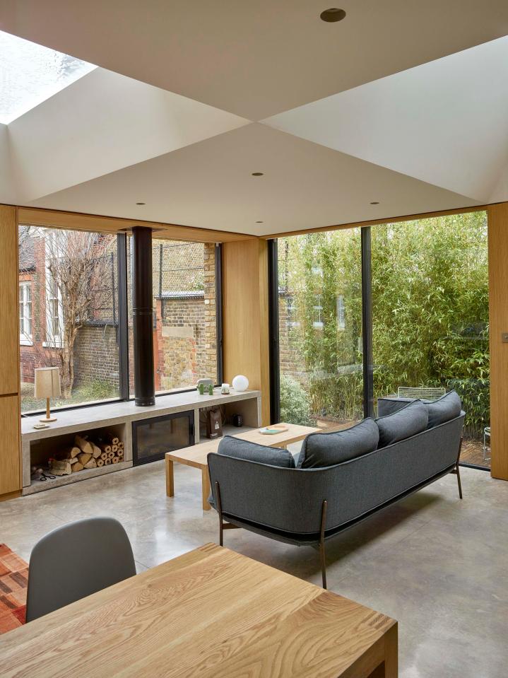  Huge wall-to-ceiling windows also bathe the property in sunlight, while the log fire means the home feels cosy