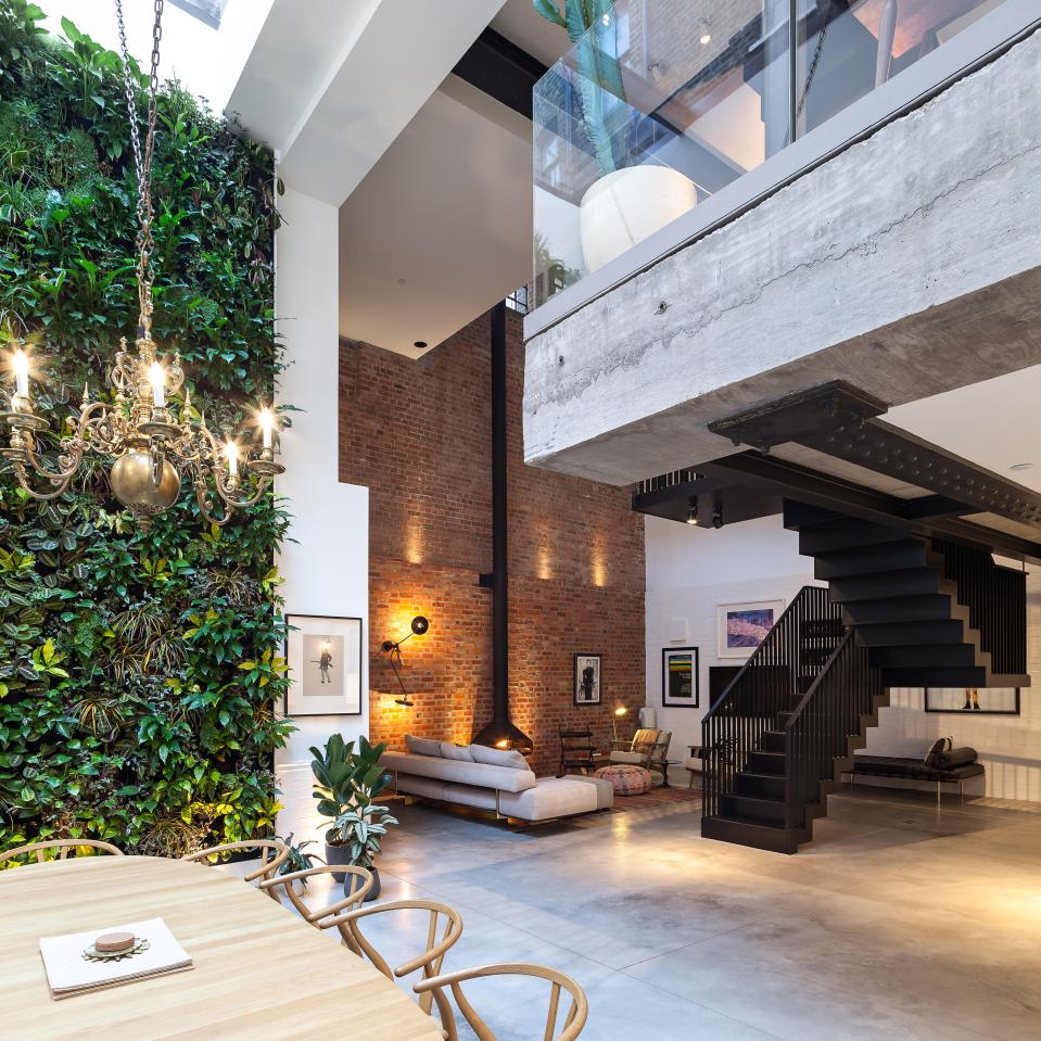  A dramatic black staircase is suspended through the middle of the property