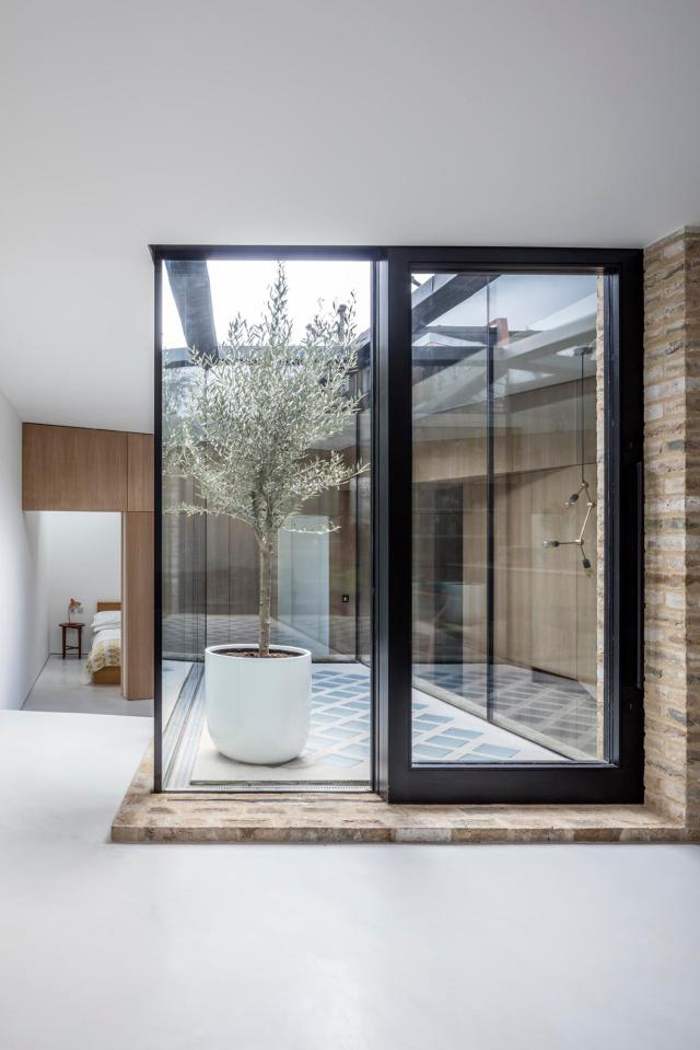  The property has no external windows, yet s bathed in natural light from an internal courtyard