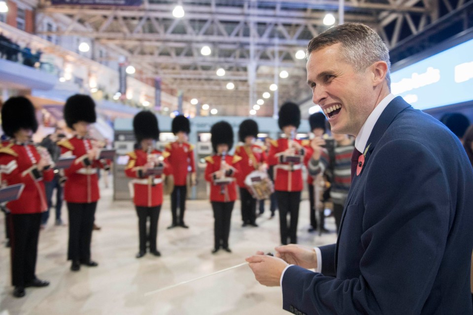 Gavin Williamson conducts the Band of the Grenadier Guards at Waterloo Station this evening