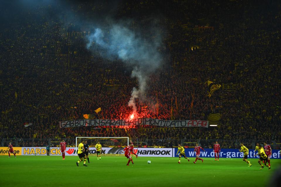  Dortmund supporters let off a flare in the crowd at the Signal Iduna Park