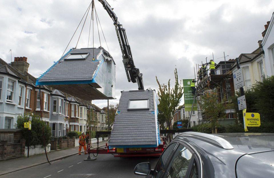 The pre-fab loft is lifted into place