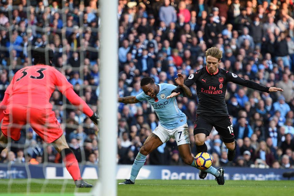  Sterling goes to ground under a challenge from Nacho Monreal