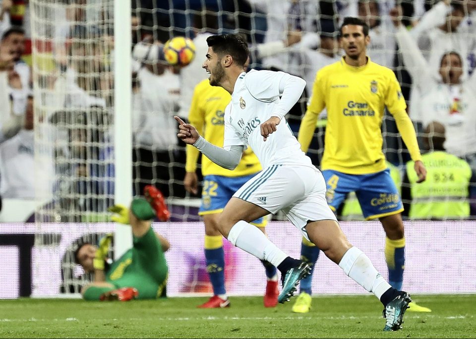  Real's Marco Asensio turns to celebrate with his shot still nestling high in the net