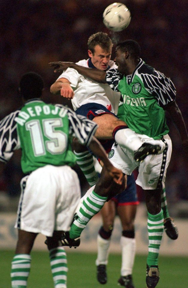  Alan Shearer heads past Austin Equaveon of Nigeria in 1994