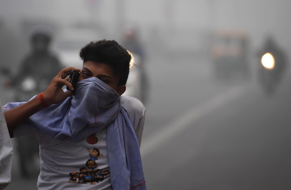 A New Delhi resident makes his way through the smog-infested city