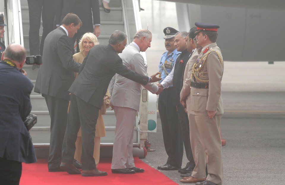 Charles and Camilla greet India officials on the toxic runway