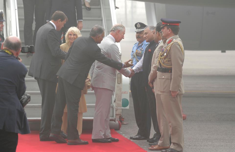  Charles and Camilla greet India officials on the toxic runway