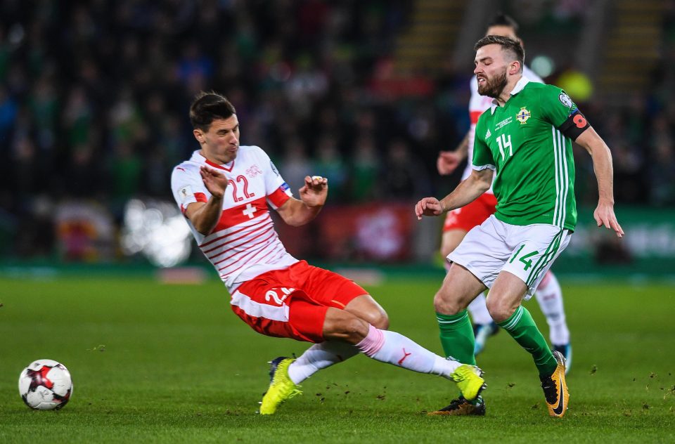  Stuart Dallas of Northern Ireland receives a heavy tackle from Fabian Schar