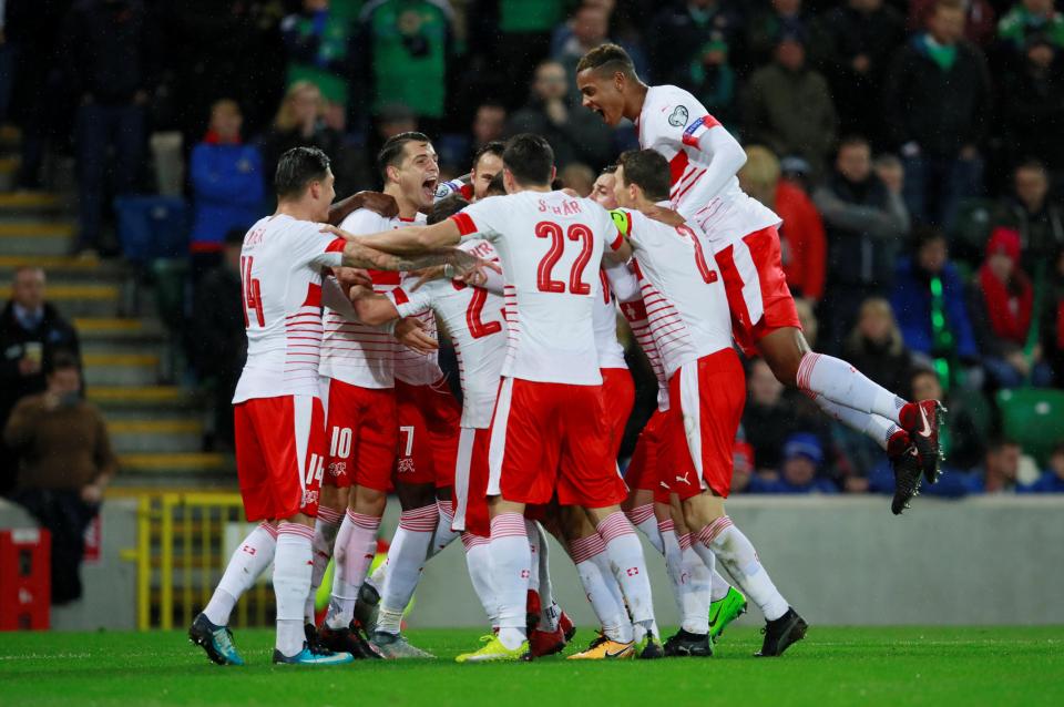  The Switzerland players celebrate the vital goal in Belfast