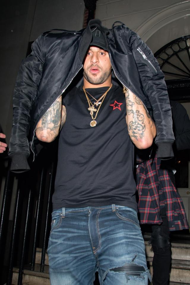  Kyle Walker popped his coat over his head on his way out