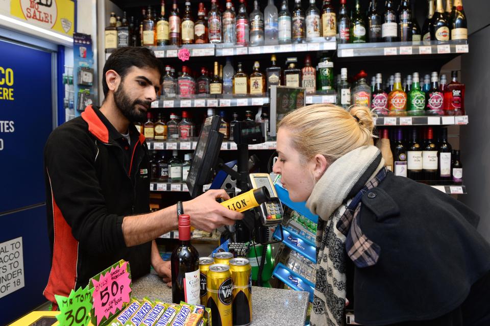  Spar worker Assad Shah breath tests a customer buying booze in Cardiff