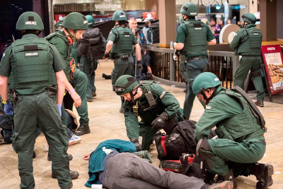  Paramedics in full protective clothing could be seen tending to the wounded outside a Costa Coffee